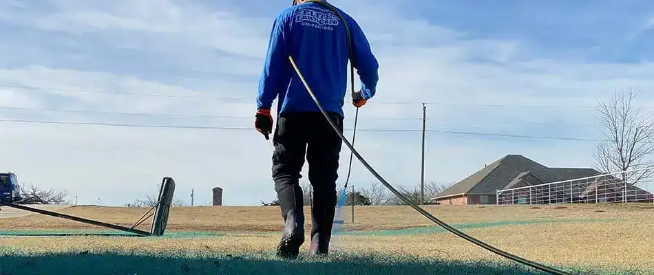 Pre-emergent weed control spray being applied to lawn