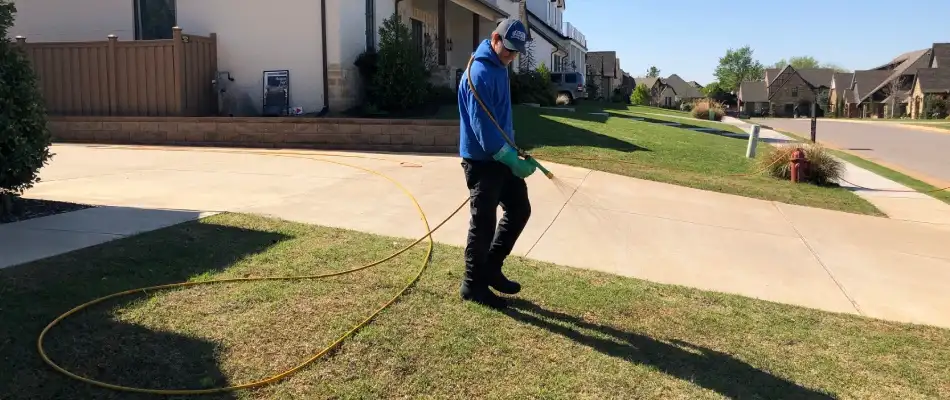 Elite professional applying soil conditioning treatment to lawn