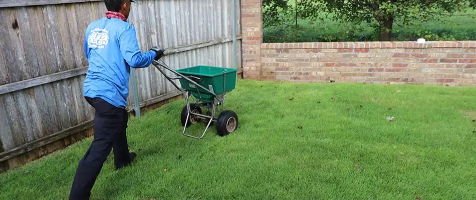 Elite worker fertilizing lawn in Del City, OK.