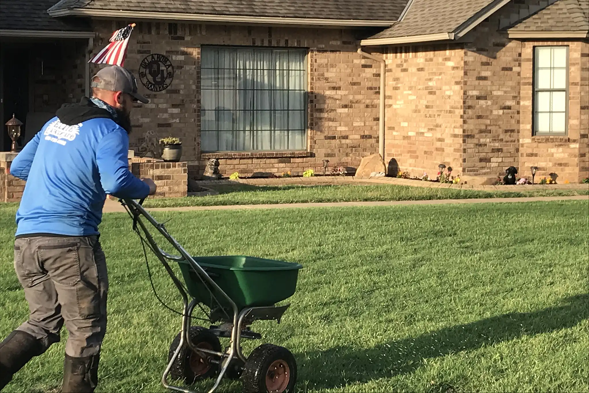 Lawn fertilization application on an OKC-area Bermuda lawn as summer heat breaks